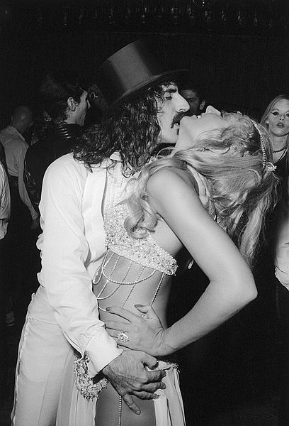 Frank Zappa celebrates his 35th birthday a bit early by embracing a showgirl at the party in his honor.SN 366-5